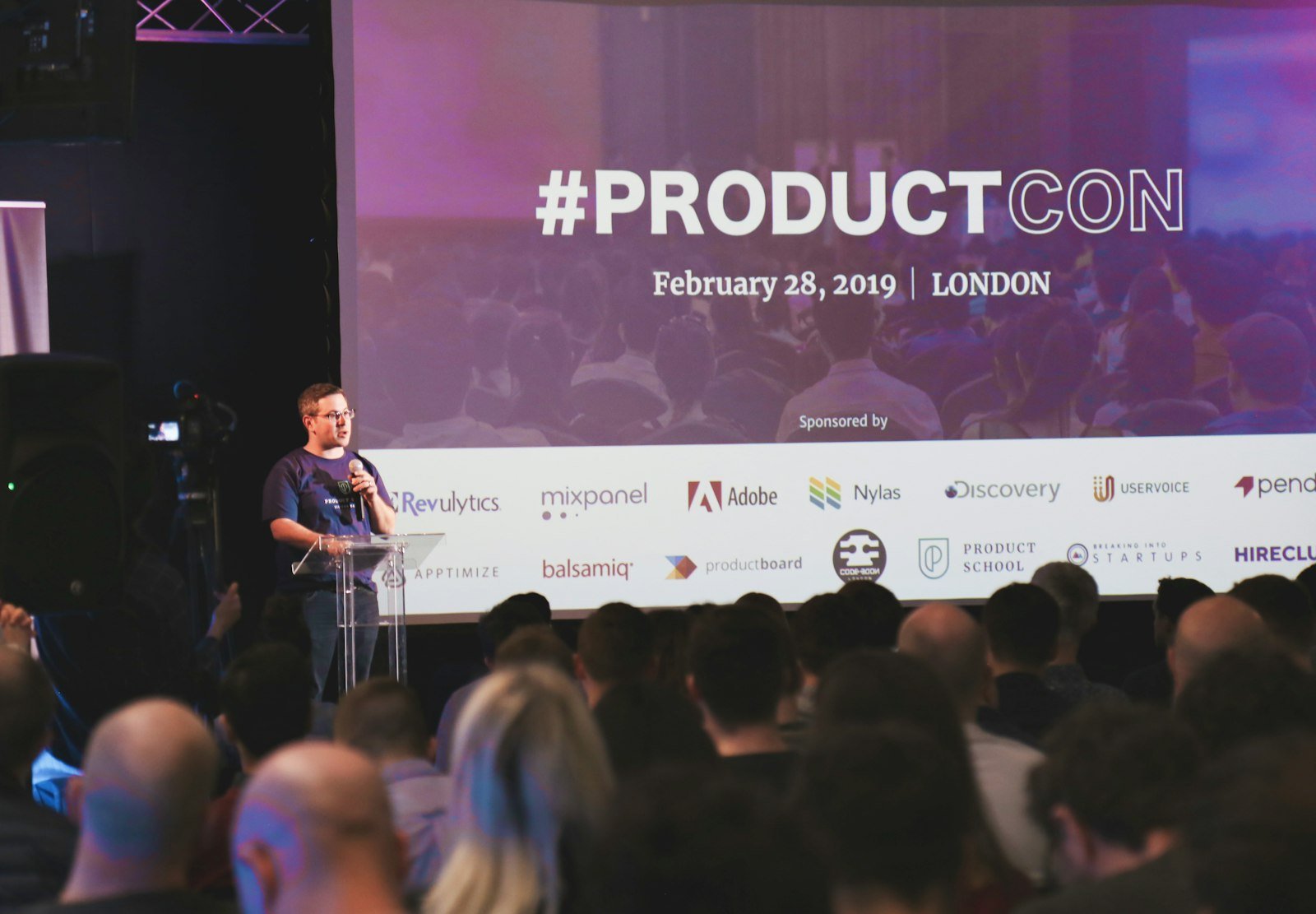 Speaker presenting on stage at a launch – product photography & event agency in Delhi