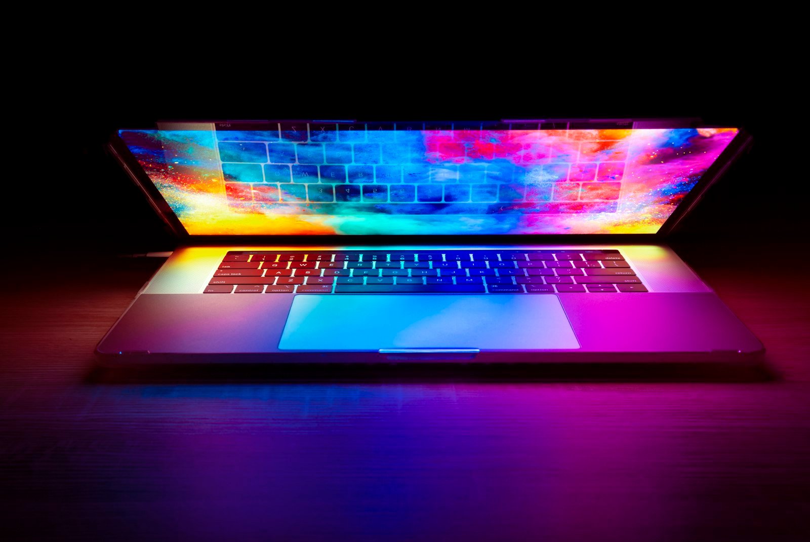 Colourful website on a laptop in a dark studio – website development company in Delhi